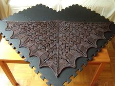 the table is made up of two large pieces of crocheted fabric on top of each other