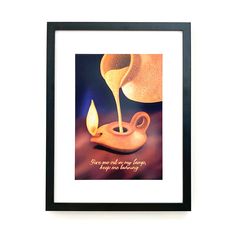 a framed photograph with a lit candle in the shape of a pot and saucer