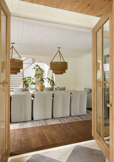 a dining room table with chairs and plants