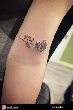 a woman's arm with a rose tattoo on the left side of her arm