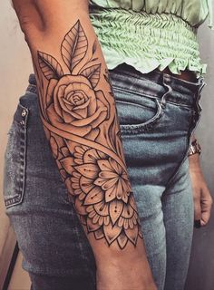 a woman's arm with a rose tattoo on it