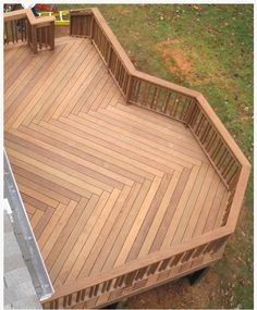 an overhead view of a wooden deck in a yard with two children playing on it