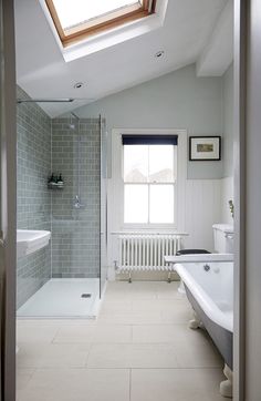 a bathroom with a skylight above the bathtub