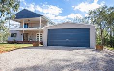 a white house with a blue garage door