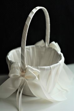 a white basket with a bow on it