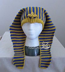 a white mannequin head wearing a blue and yellow striped knitted turban