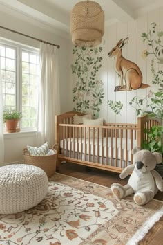 a baby's room with a crib, stuffed animal and potted plant