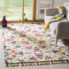 a living room with a chair and rug on the floor