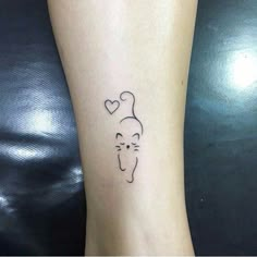 a cat with a heart tattoo on the ankle