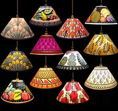 a bunch of different colored lamps hanging from a light fixture on a black background with the caption cresidabella bell