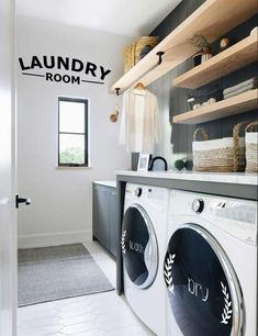 a washer and dryer in a laundry room with shelves above the washer