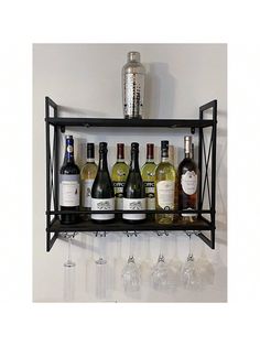 a shelf with wine glasses and bottles on it