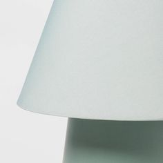 a close up of a lamp with a white shade on the top and bottom of it