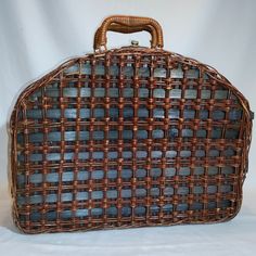 an old brown wicker purse sitting on top of a white table