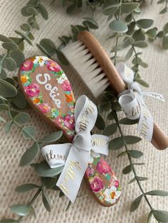 two personalized wooden brush and comb with flowers on them