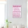 a bathroom with a pink sign on the wall and white fixtures in front of it