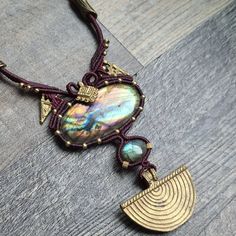 a close up of a necklace on a wooden surface