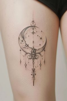 a woman's thigh with a crescent and stars tattoo on the back of her leg