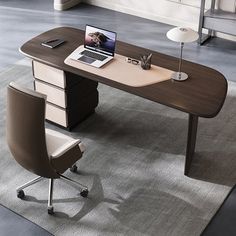 an office desk with a laptop on it and a chair in front of the desk