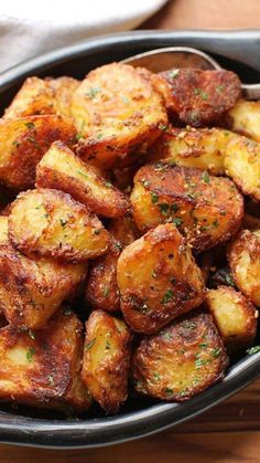 some fried potatoes are in a bowl on the table