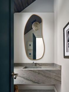 a bathroom with a sink and mirror in it