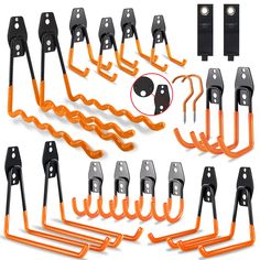 an assortment of orange and black hooks, chains, and latches on a white background