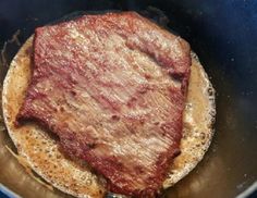 a steak is cooking in a pan on the stove