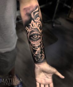 a man's arm with an all seeing eye tattoo on the left forearm and hand