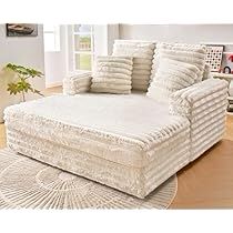 a large white couch sitting on top of a wooden floor