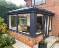 a house with an enclosed patio and sitting area