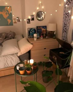 a bedroom with plants and lights on the wall next to it's bed area