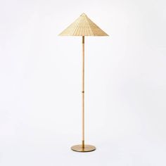 a tall bamboo floor lamp with a wooden base and an umbrella shade on the top