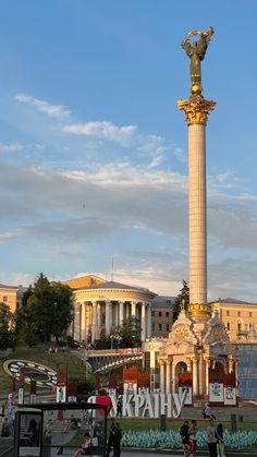 people walking around in front of a large monument