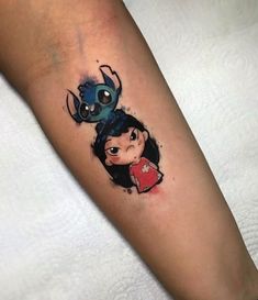 a woman's leg with a tattoo on it and an image of a cartoon character