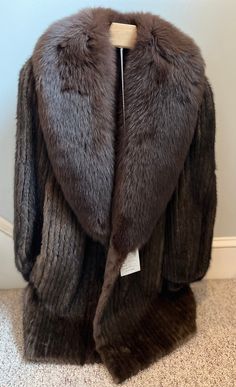 Rare find!  Vintage (1960s?) Mink Coat-unworn with original tag!- featuring mahogany-dyed fox collar and wrist hem. Fur sourced from Finland and Norway. This coat was NEVER worn- and still bears the original tag with  price that at the time was over $3800. The lining is 100% acetate (still soft and shiny) and bears the hand-sewn monogram initials of the original owner. Mint condition.  Measurements: marked women's size 6.  34" long collar to hem (back) 24" shoulder to wrist 17" across bust 12" arm hole 3" wrist hole Please read description carefully and view all photos. I describe and photograph all condition issues that I am aware of. I do my best to research and give the most accurate information regarding the item, but no one is perfect! Please do your own research if you are unsure abo Fox Collar, No One Is Perfect, Mink Coat, Jewellery Designer, Monogram Initials, Winter Looks, Vintage 1960s, Collectible Figurines, Hand Sewn