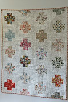 a quilt hanging on the wall in a room