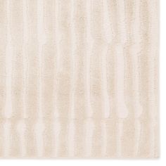 a white rug with vertical stripes on the top and bottom, in varying shades of beige