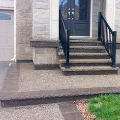 a dog is sitting on the front steps of a house