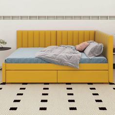 a yellow bed sitting on top of a white floor next to a black and white checkered floor