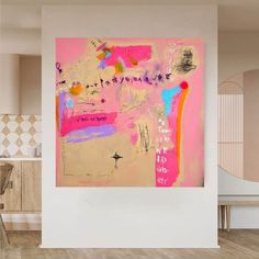 an abstract painting hangs on the wall next to a dining room table