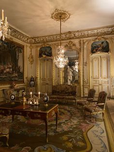 an ornately decorated living room with chandelier