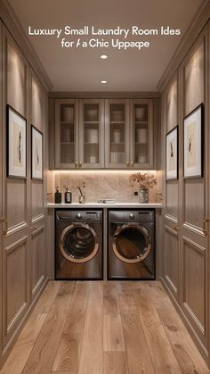 a washer and dryer in a room with wood flooring, framed pictures on the wall