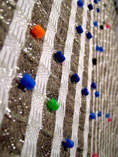 there are many different colored beads on the wall