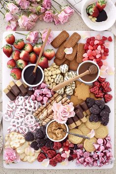 a platter filled with lots of different types of food and desserts on top of a table