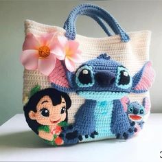 a crocheted bag with stitchs and cartoon characters on it