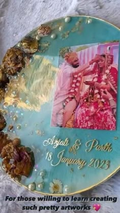 a blue plate with an image of two women in pink dresses and pearls on it