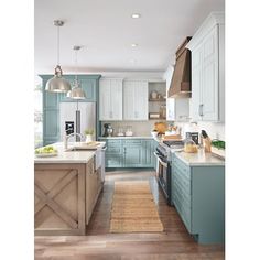 a kitchen with blue cabinets and wooden floors