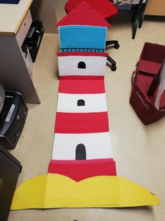 a lighthouse made out of cardboard sitting on top of a table