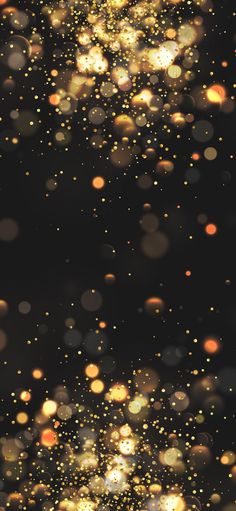 blurry image of gold sparkles against a black background