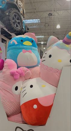 hello kitty stuffed animals are on display in a store